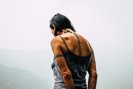 Pokhara Nepal October 2, 2018 Closeup of unknown female tourist standing under the rain in Pokhara Lakeside in the afternoonのeditorial素材