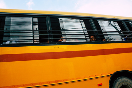 Pokhara Nepal October 4, 2018 View of a traditional Nepali yellow school bus driving in New street at pokhara in the afternoonのeditorial素材