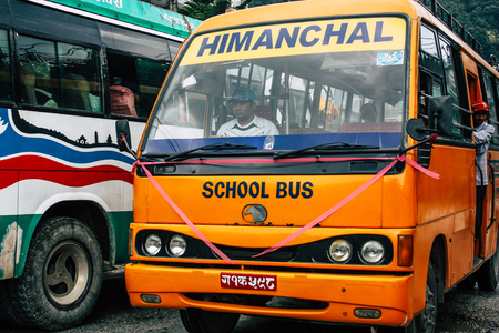 Pokhara Nepal October 4, 2018 View of a traditional Nepali yellow school bus driving in New street...