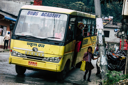 Pokhara Nepal October 4, 2018 View of a traditional Nepali yellow school bus driving in New street at pokhara in the afternoonのeditorial素材
