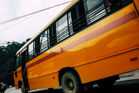 Pokhara Nepal October 4, 2018 View of a traditional Nepali yellow school bus driving in New street at pokhara in the afternoonのeditorial素材
