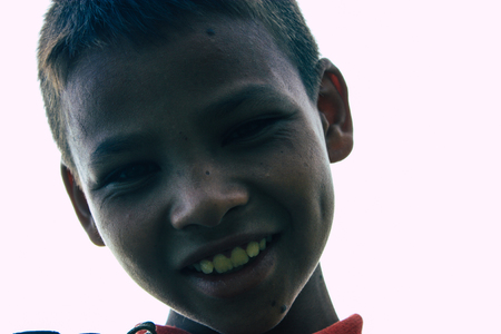 Pokhara Nepal October 6, 2018 Portrait of a young Nepali kid learning to be a paragliding pilot in the landing area front the Phewa lake of Pokharaのeditorial素材