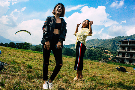Pokhara Nepal October 6, 2018 Portrait of teens having fun and taking photos front the Phewa lake in Pokhara in the afternoonのeditorial素材