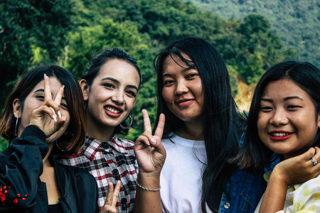 Pokhara Nepal October 6, 2018 Portrait of teens having fun and taking photos front the Phewa lake in Pokhara in the afternoonのeditorial素材