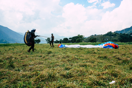 Pokhara Nepal October 6, 2018 View of a paragliding pilot landing front the Phewa lake of Pokharaのeditorial素材