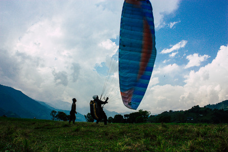 Pokhara Nepal October 6, 2018 View of a paragliding pilot landing front the Phewa lake of Pokharaのeditorial素材