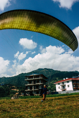 Pokhara Nepal October 6, 2018 View of a paragliding pilot landing front the Phewa lake of Pokharaのeditorial素材