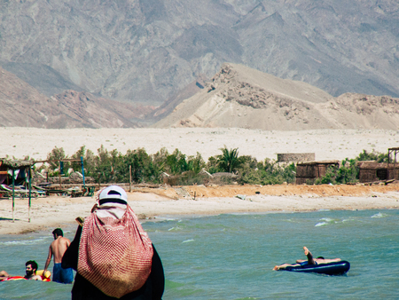 Sinai Egypt October 6, 2018 View of an Arabian women dress with burka and carrying a bag walking on...