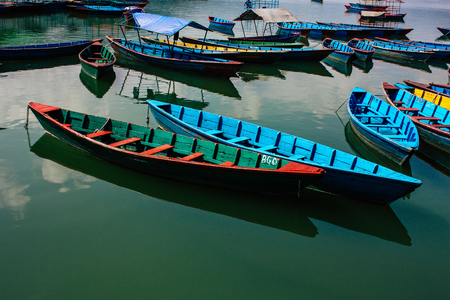 Pokhara Nepal October 9, 2018 View of colorful and traditional Nepalese boats at the Phewa lake of Pokhara in the morningのeditorial素材