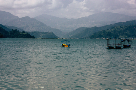 Pokhara Nepal October 9, 2018 View of colorful and traditional Nepalese boats at the Phewa lake of Pokhara in the morningのeditorial素材