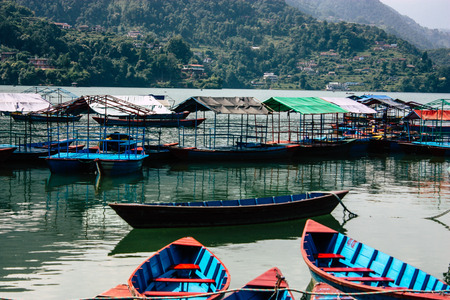 Pokhara Nepal October 9, 2018 View of colorful and traditional Nepalese boats at the Phewa lake of Pokhara in the morningのeditorial素材