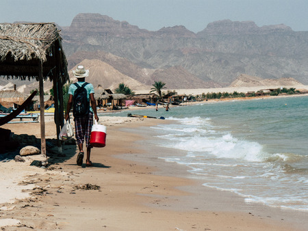 Sinai Egypt October 6, 2018 Portrait of a unknown Arabian man selling ice cream on the beach of Sinai in the morningのeditorial素材