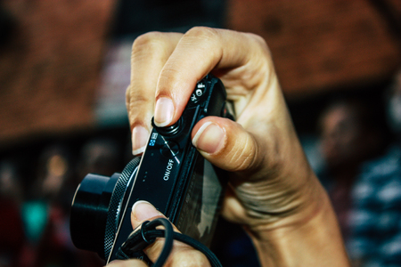 Bandipur Nepal October 18, 2018 Closeup of unknown people taking photo during a religious ceremony in Main street of Bandipur in the eveningのeditorial素材