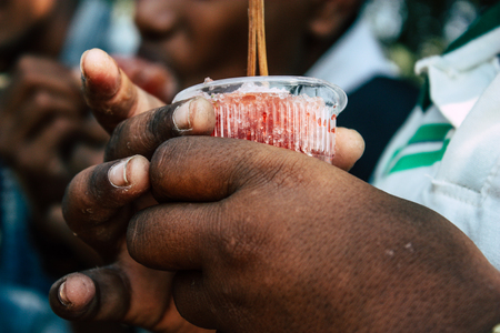 Lumbini Nepal October 31, 2018 Portrait of young unknowns teenagers eating ice cream at Buddha gardens in Lumbini in the afternoonの写真素材