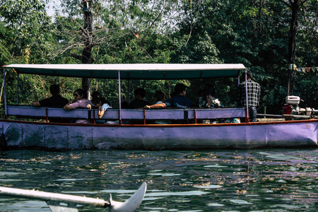 Lumbini Nepal October 31, 2018 View of a boat carrying unknowns pilgrims in the central canal of the Buddha Garden in Lumbini in the afternoonのeditorial素材