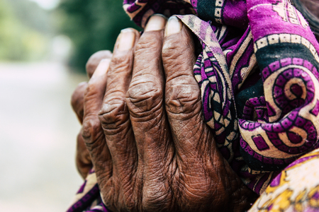 Lumbini Nepal November 3, 2018 View of unknown Nepalese old woman sitting at the entry of the Sacred...