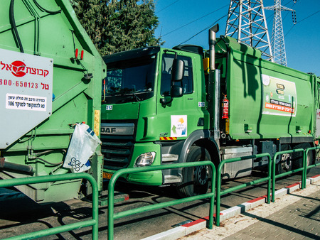 Tel Aviv Israel October 25, 2018  View of a green garbage truck parked in the streets of Tel Aviv in the afternoonのeditorial素材