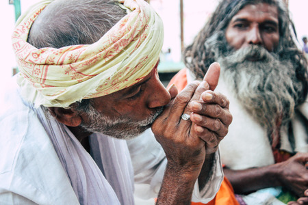 Varanasi India November 8, 2018 Sadhu sitting and smoking the shillum front the Ganges river in the afternoonのeditorial素材