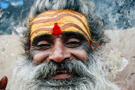 Varanasi India November 8, 2018 Sadhu sitting and smoking the shillum front the Ganges river in the...