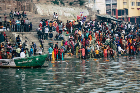 Varanasi India November 14, 2018 View of unknowns Indians people attending and celebrating Dev Deepavali on the banks of the Ganges river in the morning during the sunriseのeditorial素材