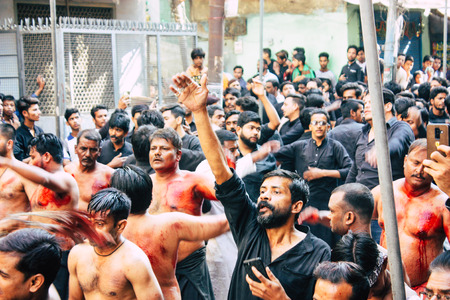 Varanasi India November 17, 2018 View of unknowns Shiite  Muslims use chains and blades during ritual self flagellation as part of the Imam Husain celebration, Ashura commemorations in the Arabian district of Varanasi in the morningのeditorial素材