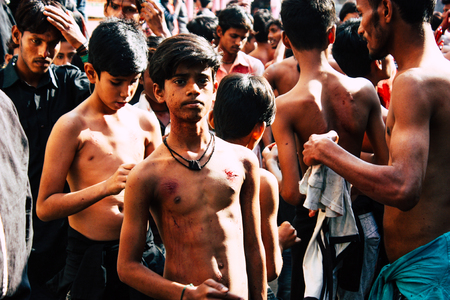 Varanasi India November 17, 2018 View of unknowns Shiite  Muslims use chains and blades during ritual self flagellation as part of the Imam Husain celebration, Ashura commemorations in the Arabian district of Varanasi in the morningのeditorial素材