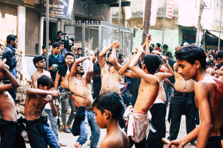 Varanasi India November 17, 2018 View of unknowns Shiite  Muslims use chains and blades during ritual self flagellation as part of the Imam Husain celebration, Ashura commemorations in the Arabian district of Varanasi in the morningのeditorial素材