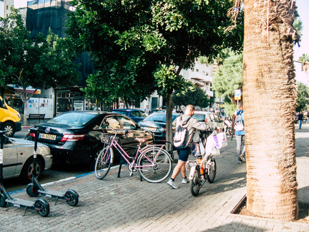 Tel Aviv Israel December 03, 2018 View of unknown Israeli people with a bicycle driving in David BEN GURION road in Tel Aviv in the afternoonのeditorial素材