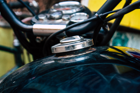 Closeup of a classic Royal Enfield motorcycle parked in the main street of Gokarna in the morningの写真素材