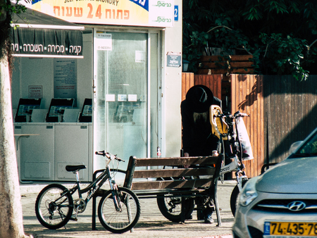 Tel Aviv Israel December 03, 2018 View of unknown Israeli people with a bicycle driving in David BEN GURION road in Tel Aviv in the afternoonのeditorial素材