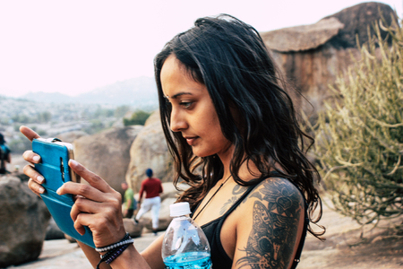 Hampi Karnataka India December 16, 2018 Portrait of Reachel Singh, Dutch professional singer taking inspiration and working on her latest album in Hampi countryside afternoonのeditorial素材