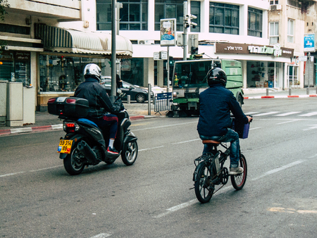 Tel Aviv Israel December 21, 2018 View of unknown Israeli people with a bicycle driving in Tel Aviv in the afternoonのeditorial素材