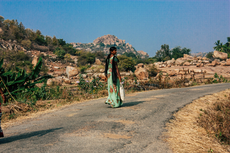Hampi Karnataka India December 20, 2018 Portrait of unknowns farmers working in a rice yard near Hampi in the morningのeditorial素材