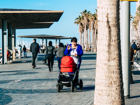 Tel Aviv Israel January 18, 2019 View of an unknown Israeli woman with her baby walking in the beach...