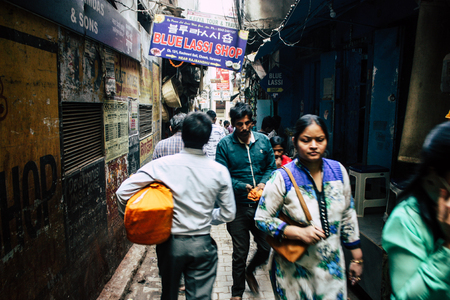 Varanasi India November 19, 2018 View of unknown Indian people walking in the narrow street in the old district of Varanasi in the afternoonのeditorial素材