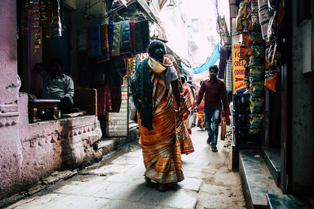 Varanasi India November 19, 2018 View of unknown Indian people walking in the narrow street in the old district of Varanasi in the afternoonのeditorial素材