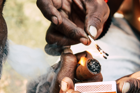 Varanasi India November 19, 2018 View of a unknown Sadhu smoking a chillum in the streets of...