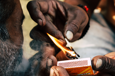 Varanasi India November 19, 2018 View of a unknown Sadhu smoking a chillum in the streets of Varanasi in the afternoonのeditorial素材
