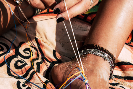 Gokarna Karnataka India January 24, 2019 Closeup of a Israeli girl making makrame in OM beach in the afternoonのeditorial素材