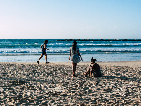 Tel Aviv Israel February 9, 2019 View of unknown Israeli people running on the beach of Tel Aviv in the afternoonのeditorial素材