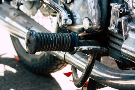 Closeup of a classic motorcycle parked in the streets of Mumbai in the afternoon