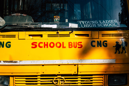 Mumbai India March 3, 2019 View of traditional yellow school bus parked in the streets of Mumbai in the afternoonのeditorial素材