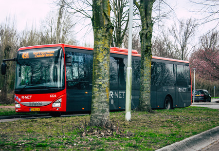 Papendrecht Netherlands March 12, 2019 View of a classic Duch city bus rolling in the streets of Papendrecht in the afternoonのeditorial素材