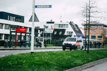 Papendrecht Netherlands March 12, 2019 View of a Duch police car rolling in the streets of Papendrecht in the afternoonのeditorial素材