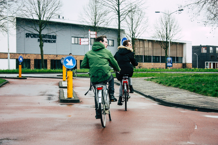 Papendrecht Netherlands March 12, 2019 View of unknown Dutch people with a bicycle in the streets of Papendrecht in the afternoonのeditorial素材