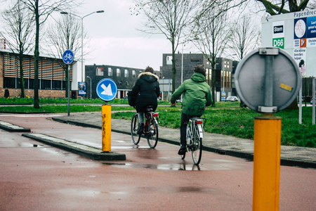 Papendrecht Netherlands March 12, 2019 View of unknown Dutch people with a bicycle in the streets of Papendrecht in the afternoonのeditorial素材