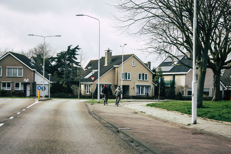 Papendrecht Netherlands March 12, 2019 View of unknown Dutch people with a bicycle in the streets of Papendrecht in the afternoonのeditorial素材