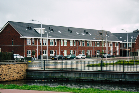 Papendrecht Netherlands March 12, 2019 View of the traditional Dutch lower brick building located in the streets of Papendrecht in the afternoonのeditorial素材