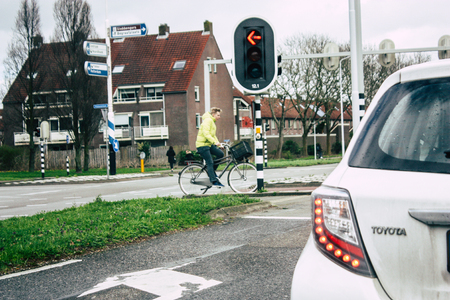 Papendrecht Netherlands March 12, 2019 View of unknown Dutch people with a bicycle in the streets of Papendrecht in the afternoonのeditorial素材