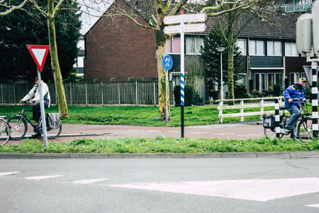 Papendrecht Netherlands March 12, 2019 View of unknown Dutch people with a bicycle in the streets of Papendrecht in the afternoonのeditorial素材